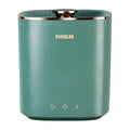 Green and white mini portable washing machine for underwear and socks on a countertop.