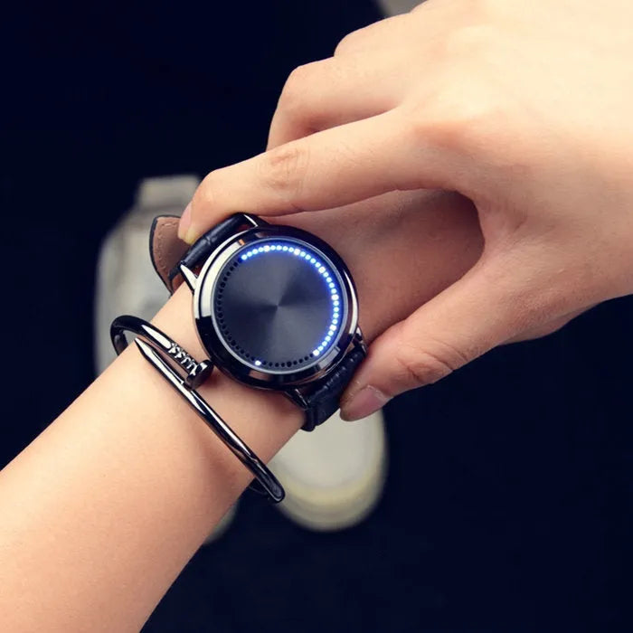 Casual digital wristwatch with blue luminous display and electronic movement in black or white.