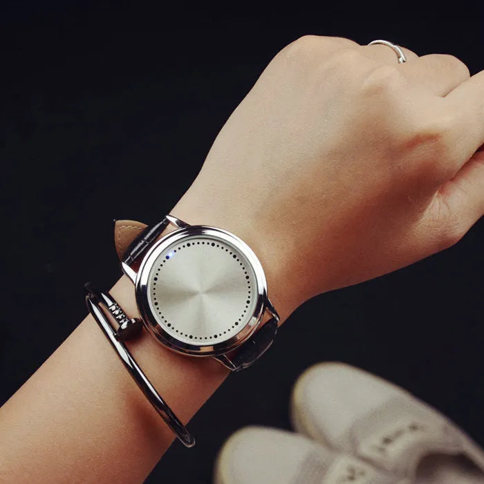 Casual digital wristwatch with blue luminous display and electronic movement in black or white.