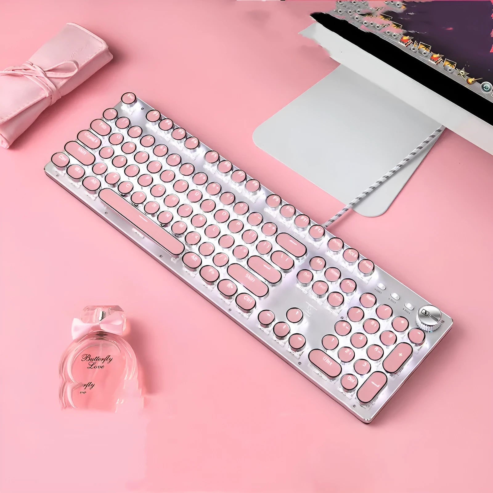 Queen Lipstick mechanical keyboard with pink keys on silver frame showing white backlighting