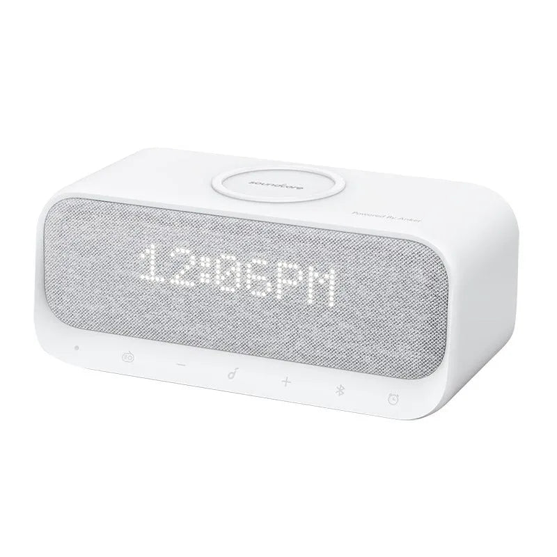 White or pink Anker Soundcore Bluetooth speaker with wireless charging pad and digital clock display