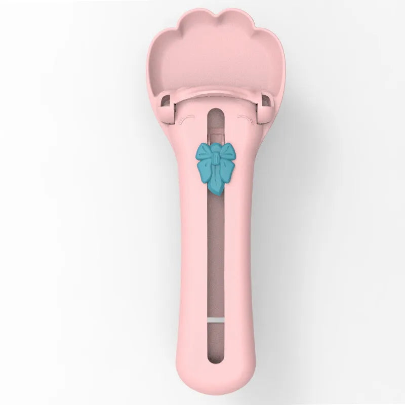 Green and pink pet feed spoon with integrated treat extrusion tool and liquid food squeezer feeder
