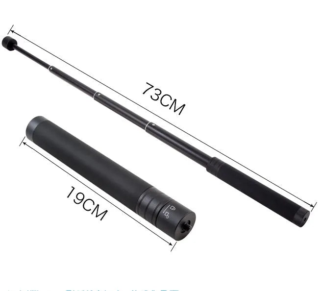 Black retractable selfie stick extended with phone in holder and visible wrist strap.