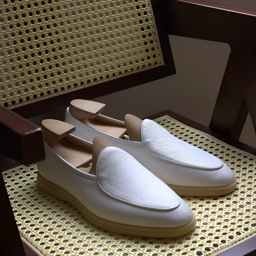 Men's brown genuine leather handmade loafers on a white background.