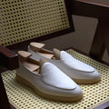 Men's brown genuine leather handmade loafers on a white background.