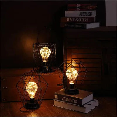 Minimalist wrought iron hollow table lamp in red wine glass style with warm white glow.