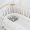 Baby crib bumper in crystal velvet with braid knot design showing flexible length options for cot protection