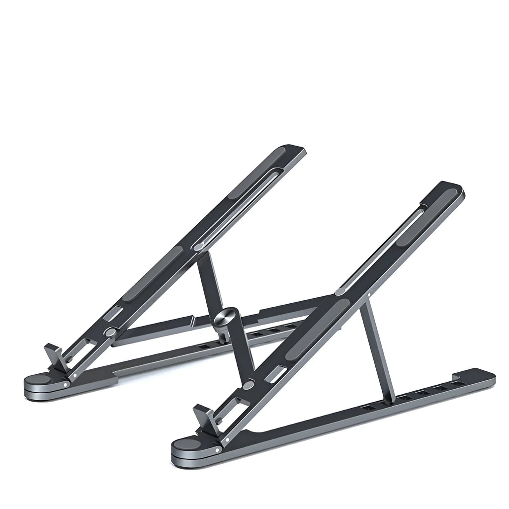 Aluminium laptop stand in silver, folded flat next to an open laptop showing its adjustable height mechanism.