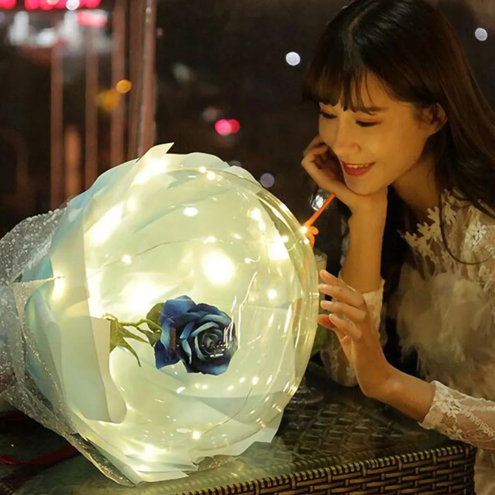 DIY LED luminous transparent balloon with artificial rose and lights inside for decoration.