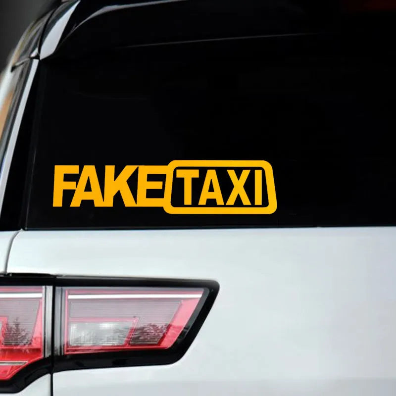 Yellow Fake Taxi waterproof car sticker on a vehicle window, showing 20cm by 8cm size.