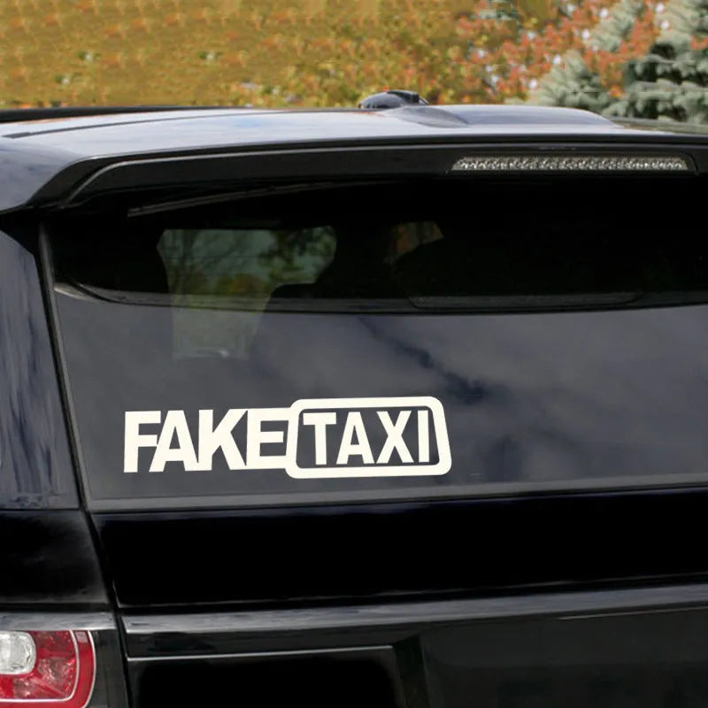Yellow Fake Taxi waterproof car sticker on a vehicle window, showing 20cm by 8cm size.