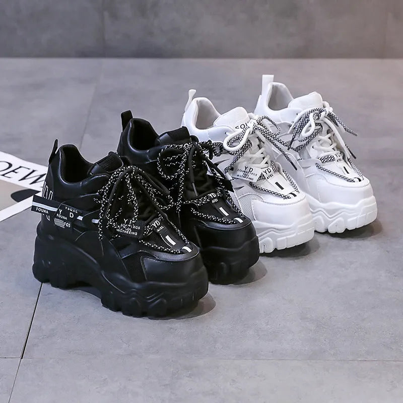 White women's mesh platform sports shoes with cross-strap detail and rubber sole.