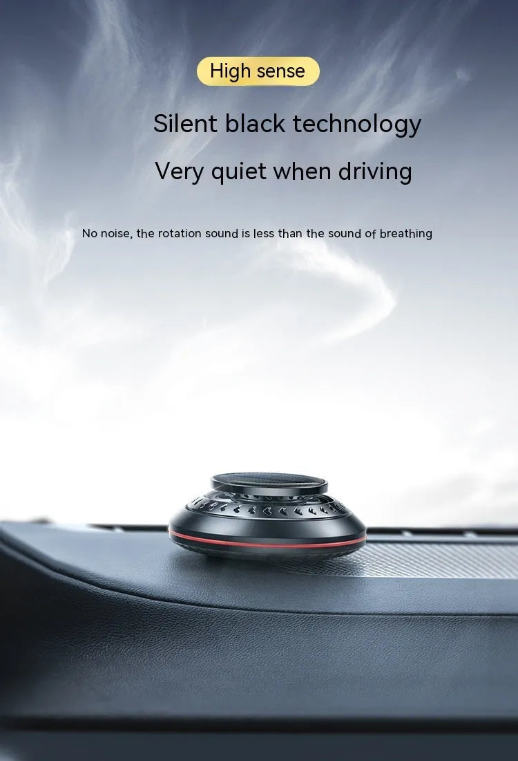 Compact black solar-powered aluminium alloy car air freshener for odour removal on a car dashboard