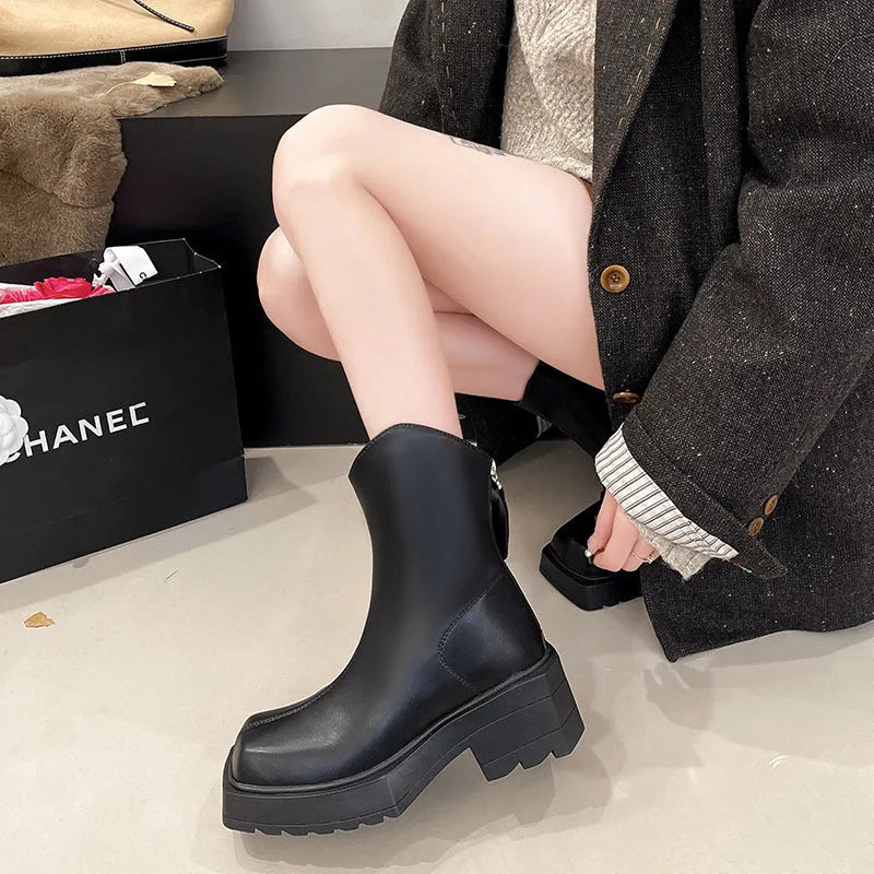 Black square toe platform Martin boots for women with a chunky rubber sole and back zip.