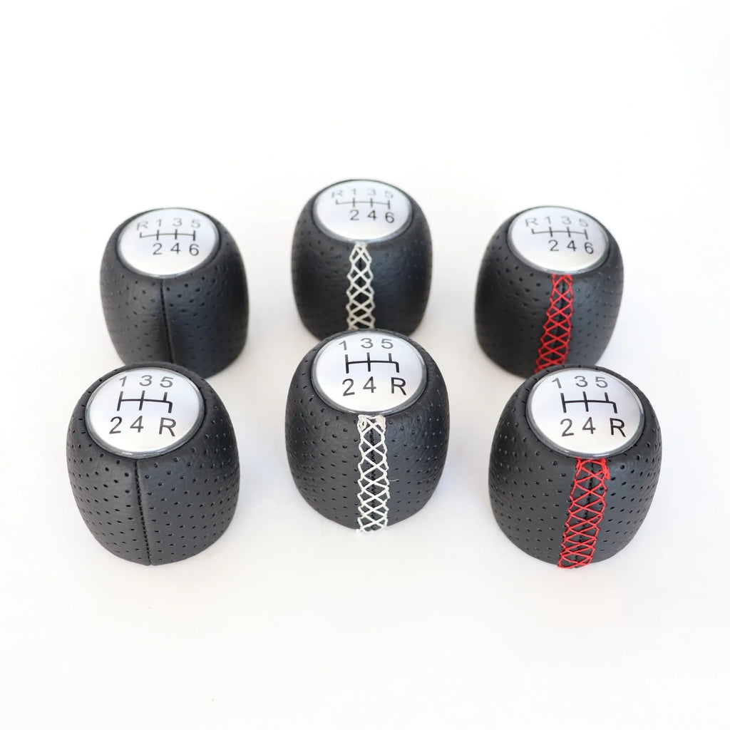 Black perforated PU leather gear knob for Alpha car with sewn seam, shown next to red and white line options.