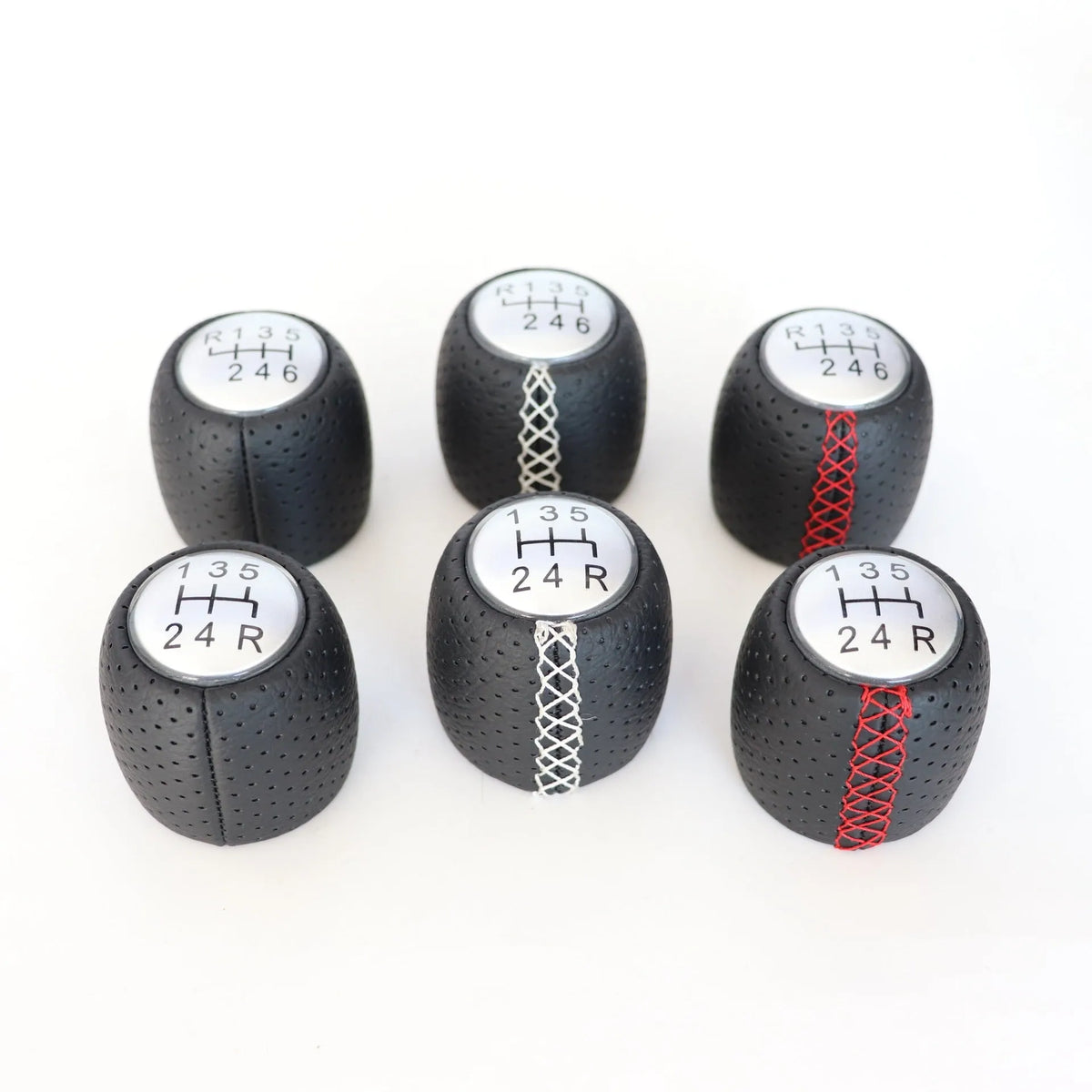 Black perforated PU leather gear knob for Alpha car with sewn seam, shown next to red and white line options.