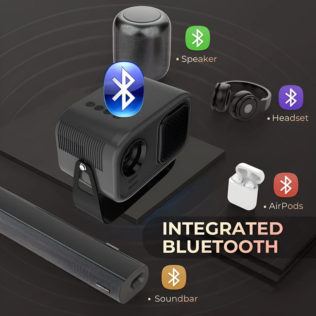 Black portable smart projector with remote control and cables on desk