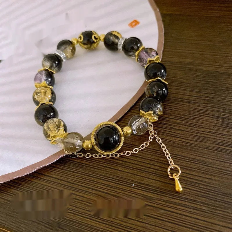 Chinese style handmade glass bead bracelet with bamboo joint elements on a white background.