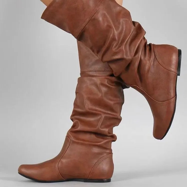 Women's flat round toe slip-on ankle boots in artificial PU leather with a high cylinder shaft.