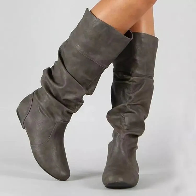 Women's flat round toe slip-on ankle boots in artificial PU leather with a high cylinder shaft.