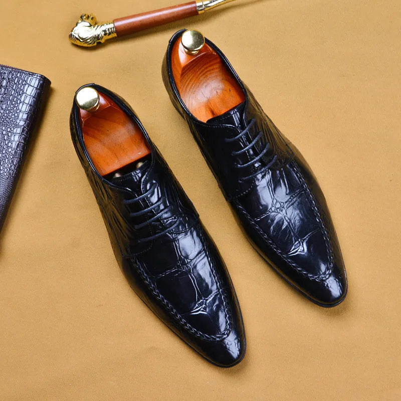 Black men's leather loafers with a silver horsebit buckle on a pointed toe, side view.