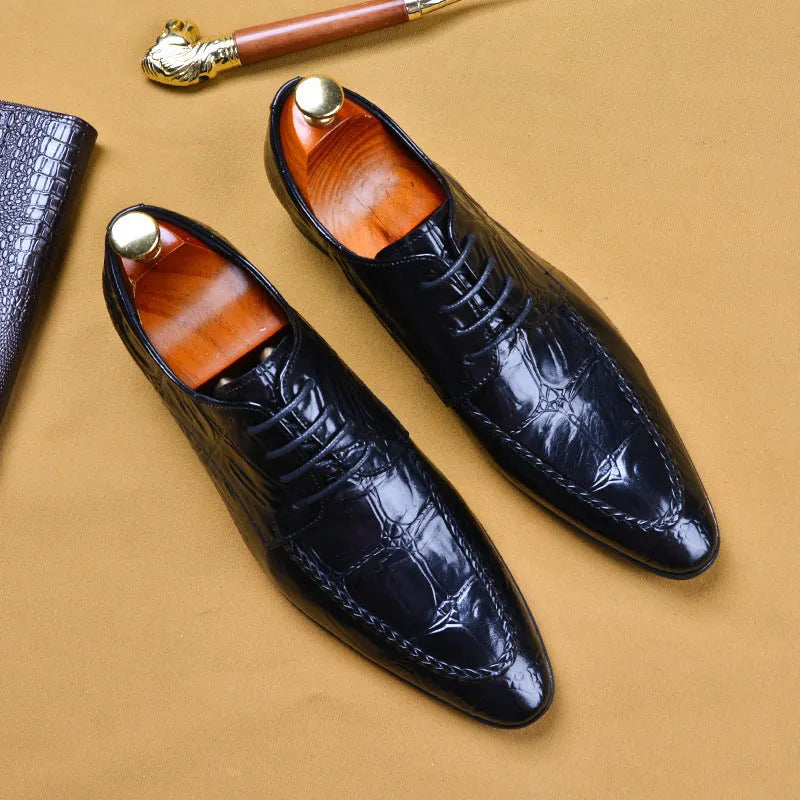 Black men's leather loafers with a silver horsebit buckle on a pointed toe, side view.