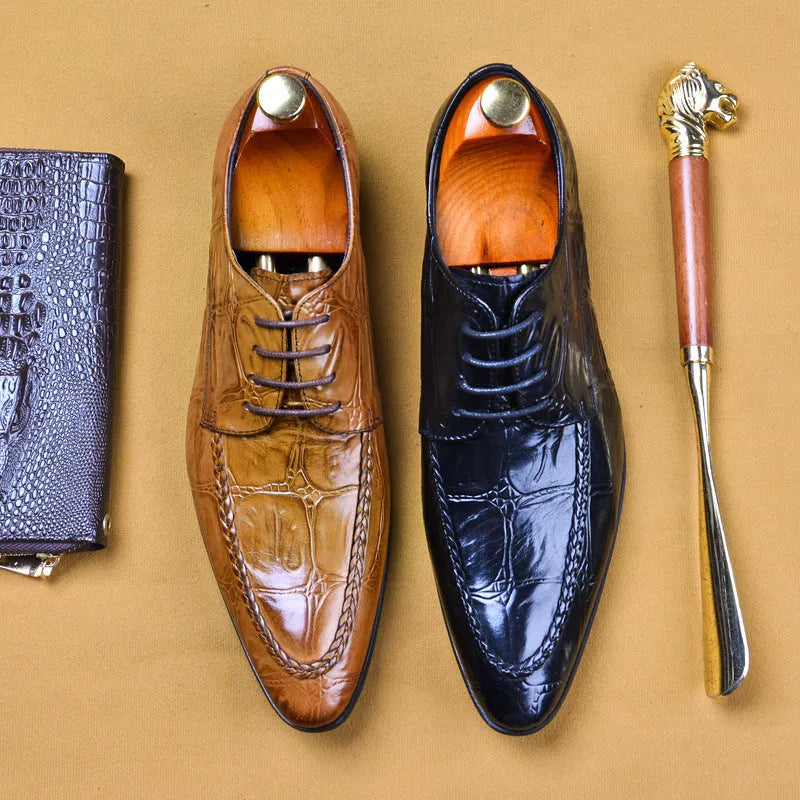 Black men's leather loafers with a silver horsebit buckle on a pointed toe, side view.