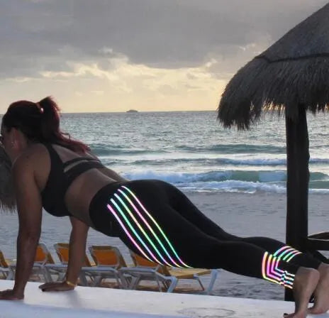 Women's black printed Milk Silk workout leggings with a slim fit, shown from the side.