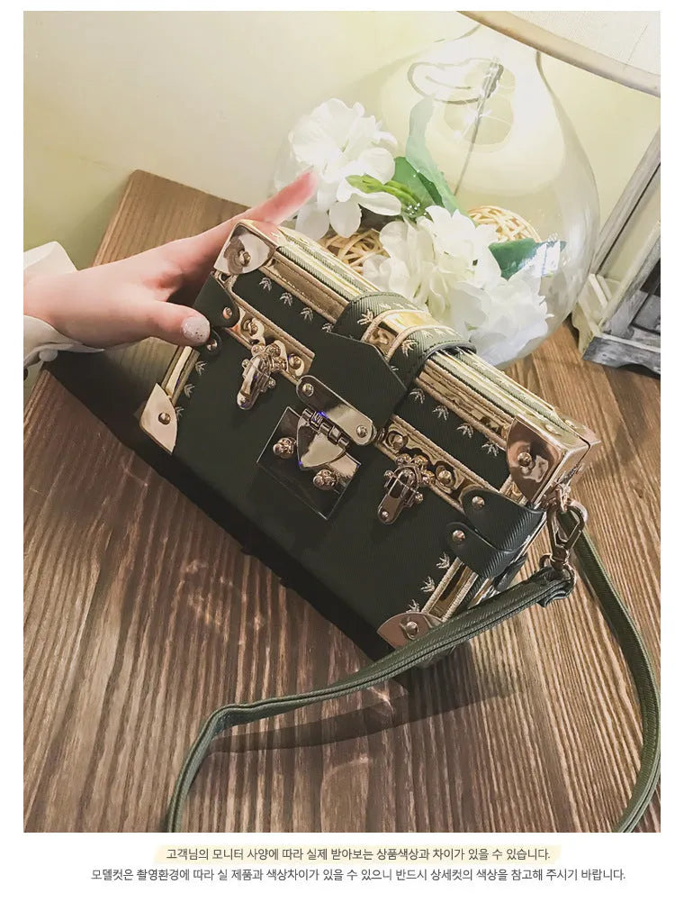 Women's hard-sided black PU shoulder bag with single strap and flap closure