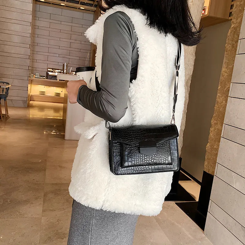 Vintage PU leather crossbody bag in black, shown with adjustable strap.