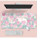 Large floral pattern mouse pad with extended keyboard area on wooden desk