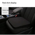 Black car seat cushion adding 6cm of height on a vehicle seat.