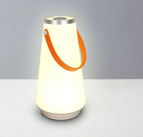 White rechargeable LED bedside lantern with warm light, shown next to a USB charging cable.