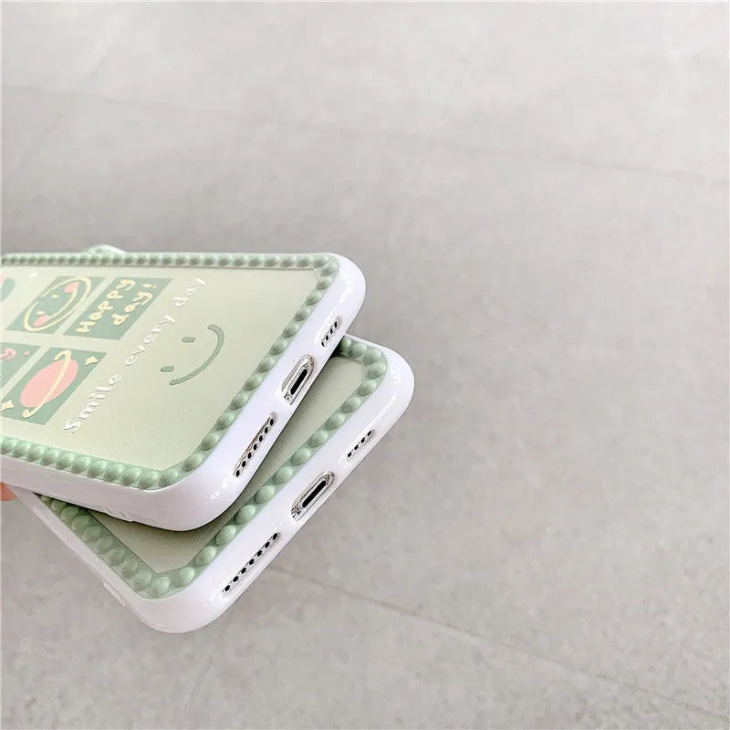 Green TPU iPhone case with geometric smiley face and polka dot design on a simple back cover.