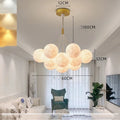 Nordic moon bubble chandelier with gold finish and spherical decorative elements for bedroom ceiling lighting