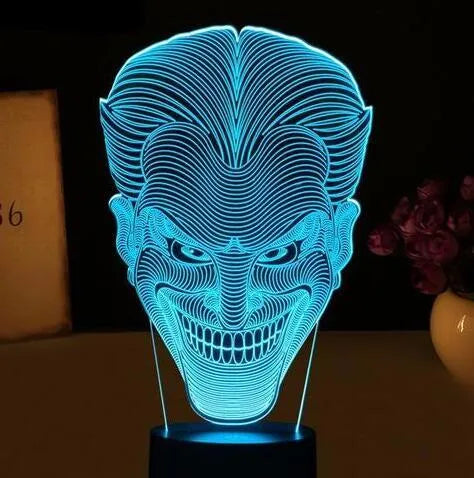 A 3D acrylic LED lamp displaying a gradient of colours, sitting on a square base with a USB cable.