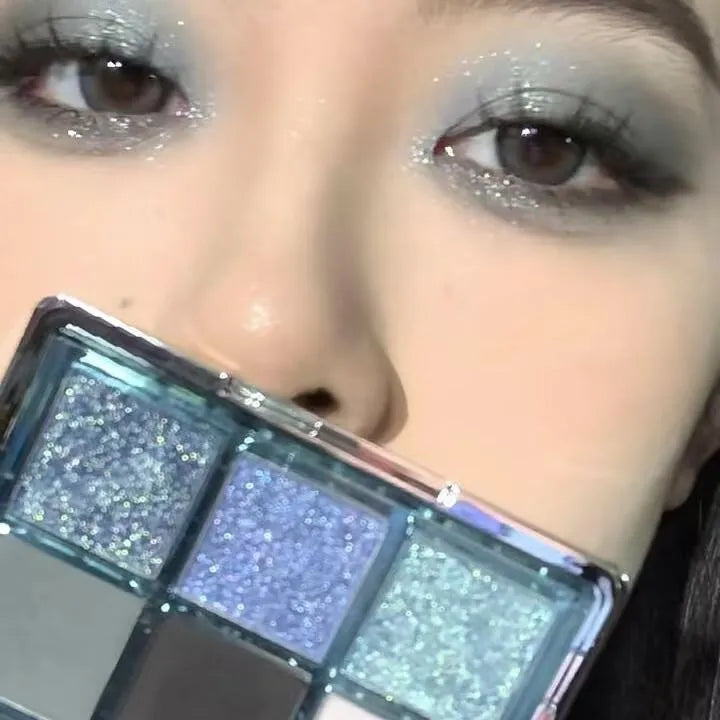 MUGELEEN nine-colour eye shadow palette showing blue smoked earth tones with matte and shimmer textures