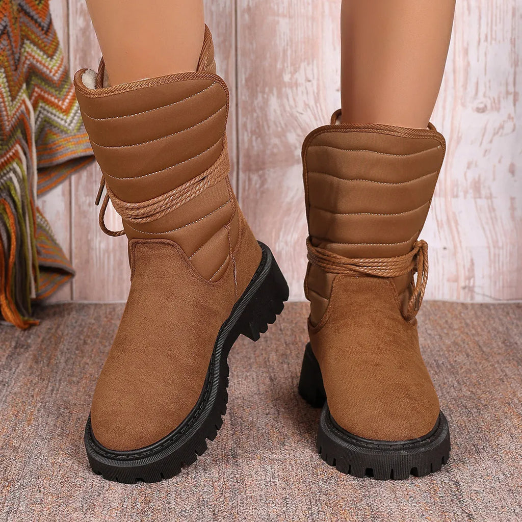Women's black suede snow boots with chunky heel, lace-up front, and fleece lining.