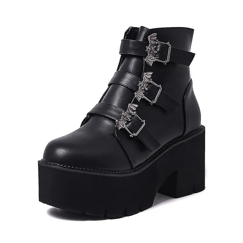 Black women's gothic punk Martin boots with bat buckle and side zipper on a thick heel.