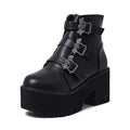 Black women's gothic punk Martin boots with bat buckle and side zipper on a thick heel.