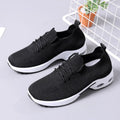 Women's grey lace-up sneakers with mesh upper and soft PVC sole on a light background.