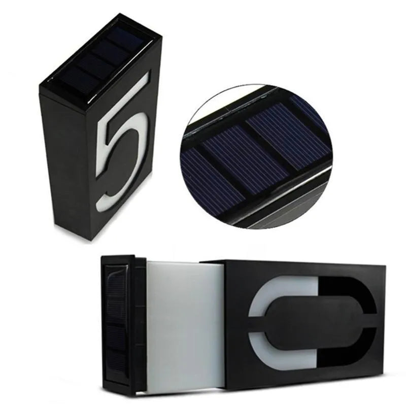 Solar powered house number light with white LED and waterproof casing mounted on an exterior wall