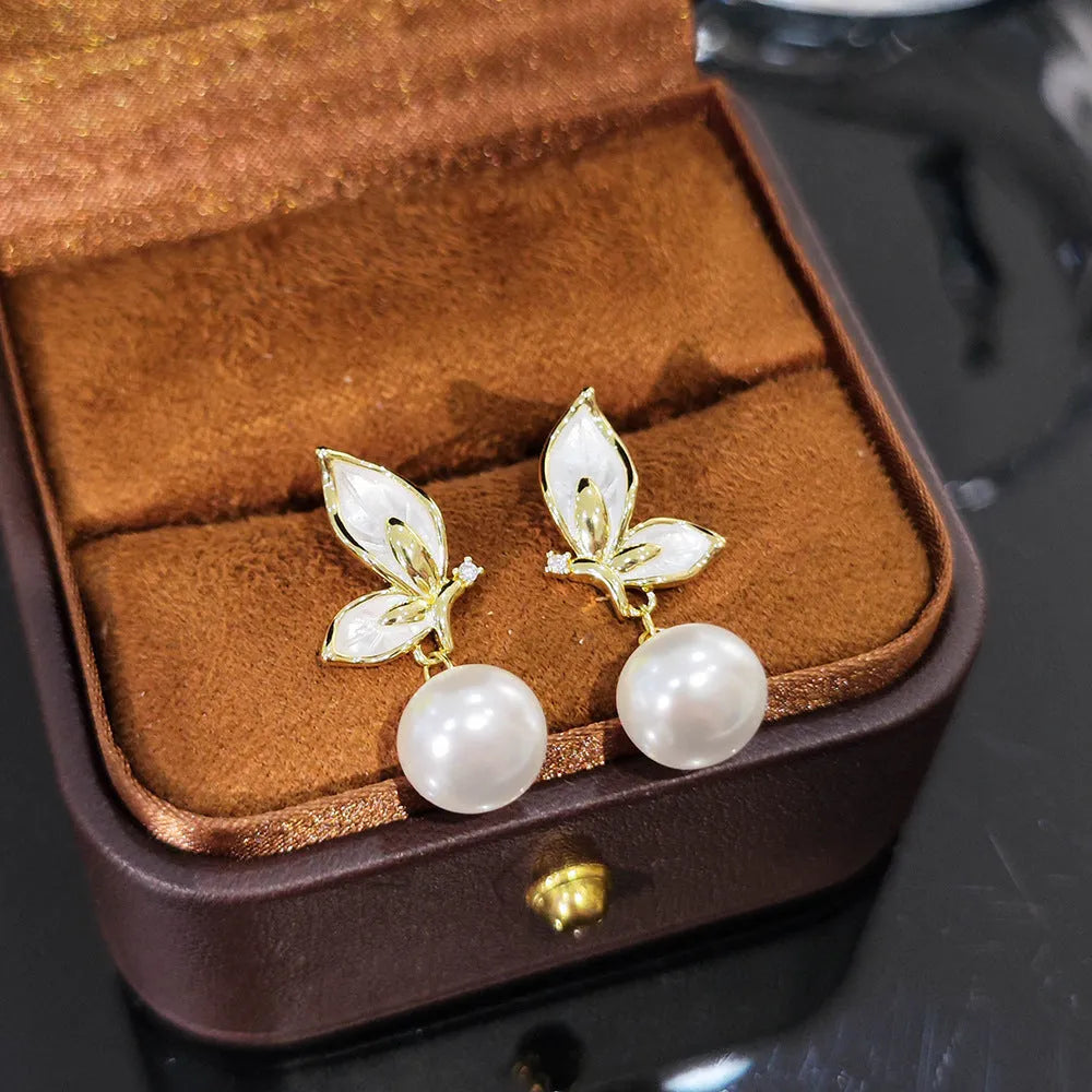 Butterfly-shaped drop earrings for women with oil painting design and zircon stone accents on copper.