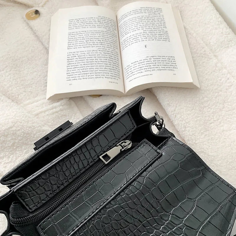 Vintage PU leather crossbody bag in black, shown with adjustable strap.