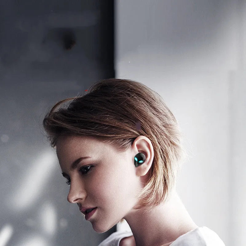 Creative Outer T8 Starman alien design true wireless Bluetooth earbuds with LED lights in charging case.
