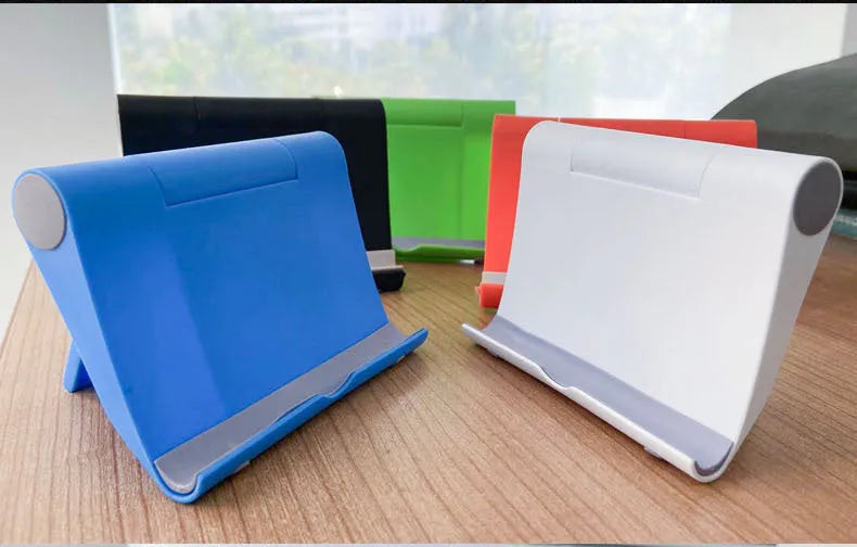 Black PE folding mobile phone stand with soft rubber grips holding a tablet at an adjustable angle