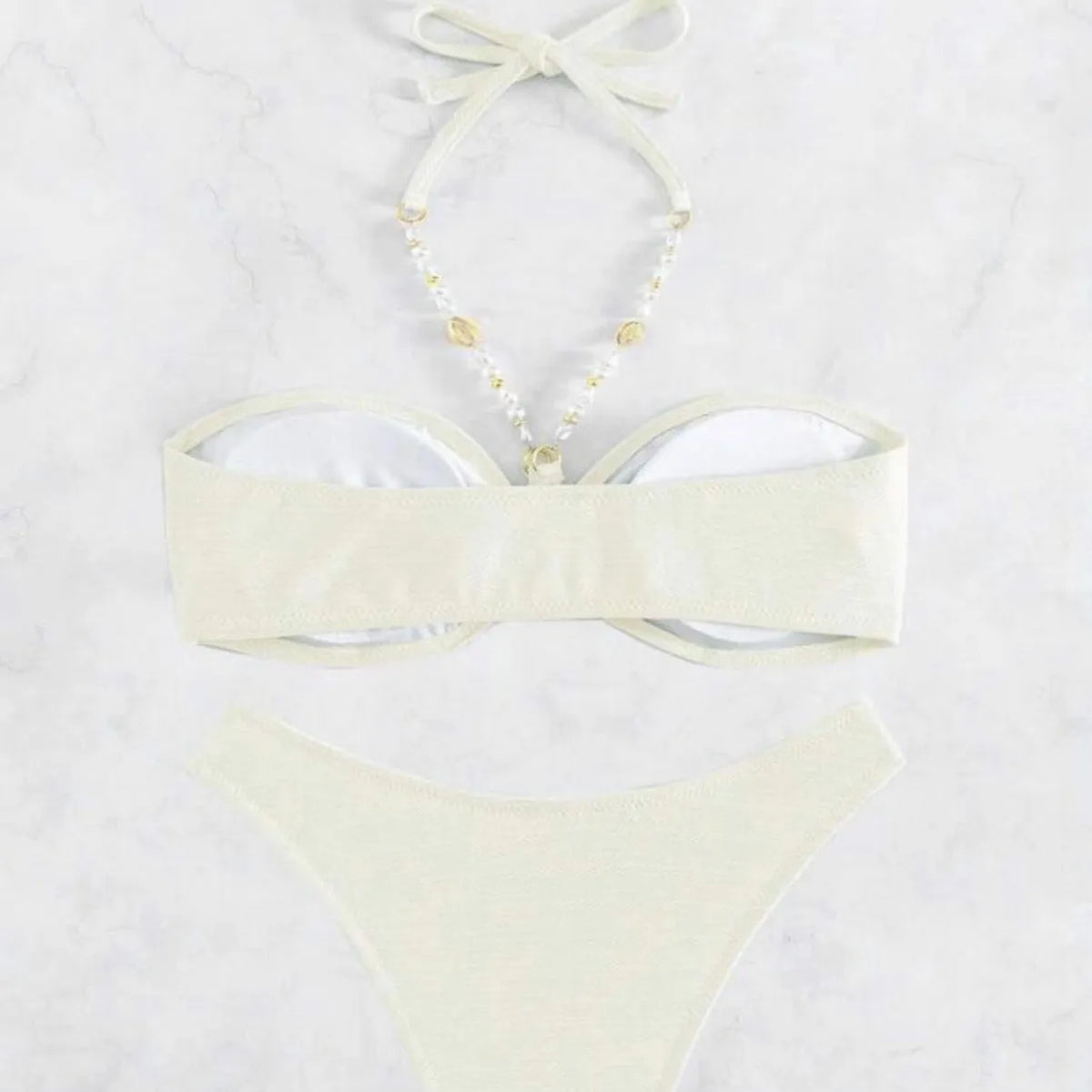 Women's halter-style bikini set in solid colour on a white background.