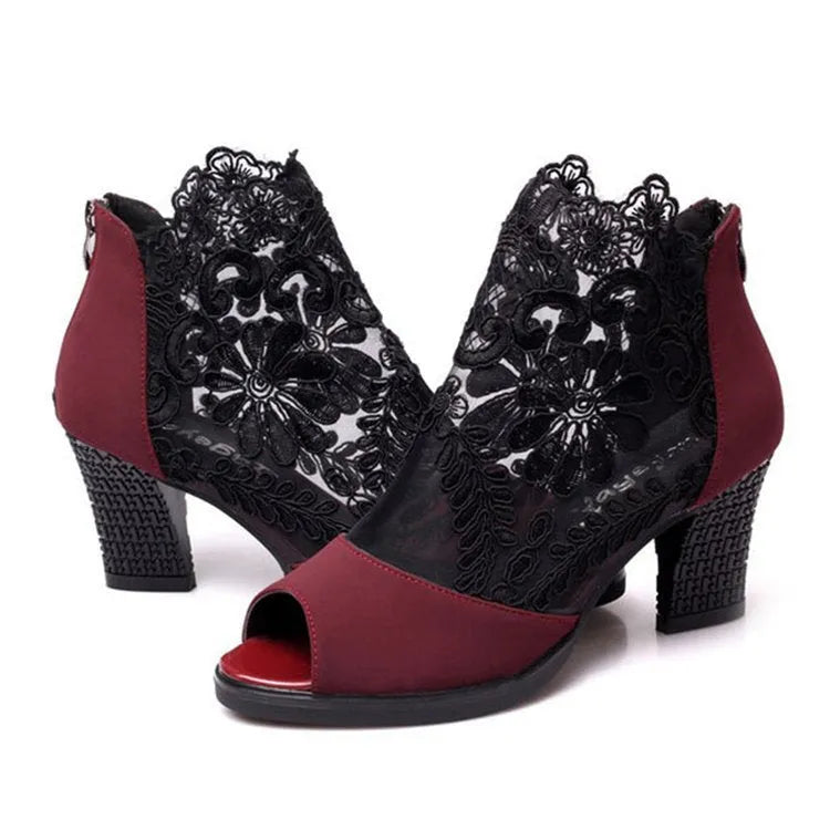 Black women's gladiator sandals with floral lace upper, square high heel, peep toe, and zip closure.