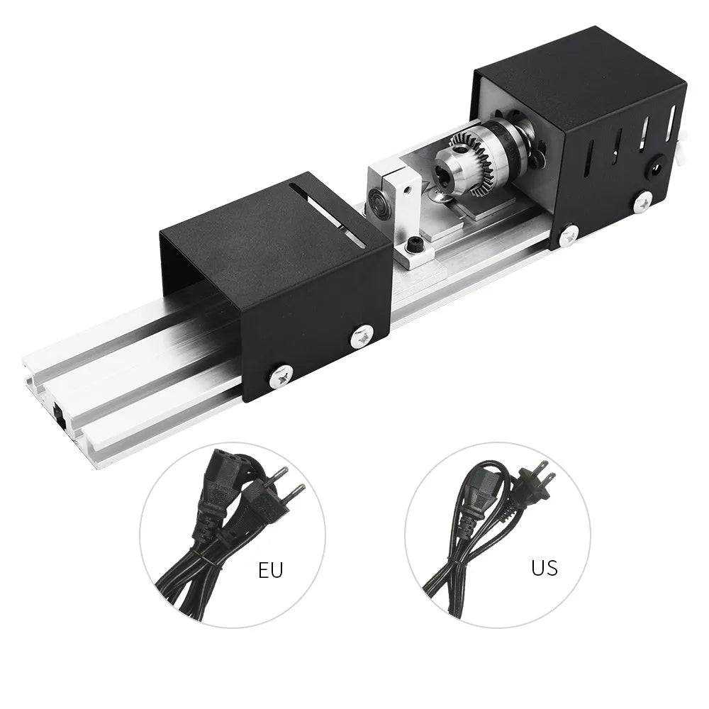 Silver metal manual mini woodworking lathe with carving tools on a workbench.