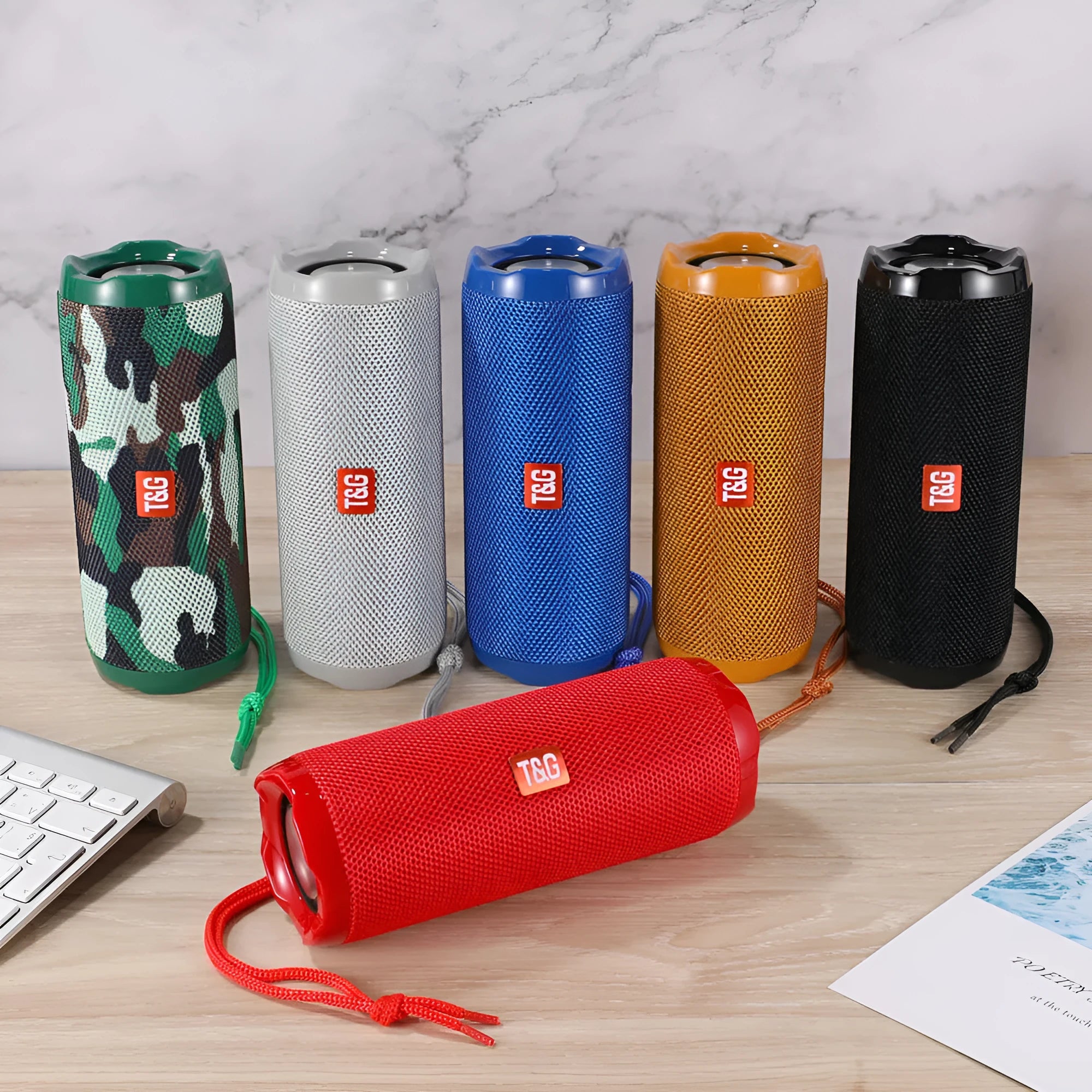 Fabric-covered portable Bluetooth speaker with card holder slots, shown in multiple colour options.
